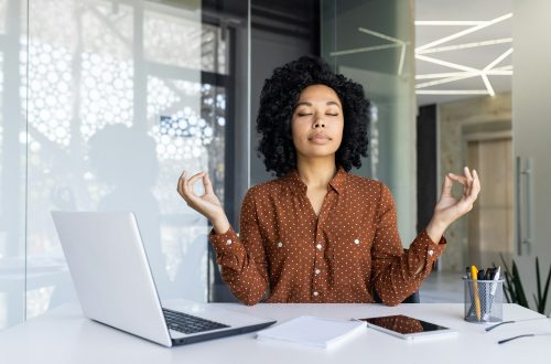 Businesswoman practicing mindfulness at her office desk