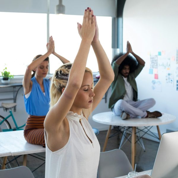 Executives doing yoga in office