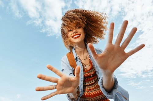 Smiling Woman Dancing on Beach, Embracing Freedom and Happiness